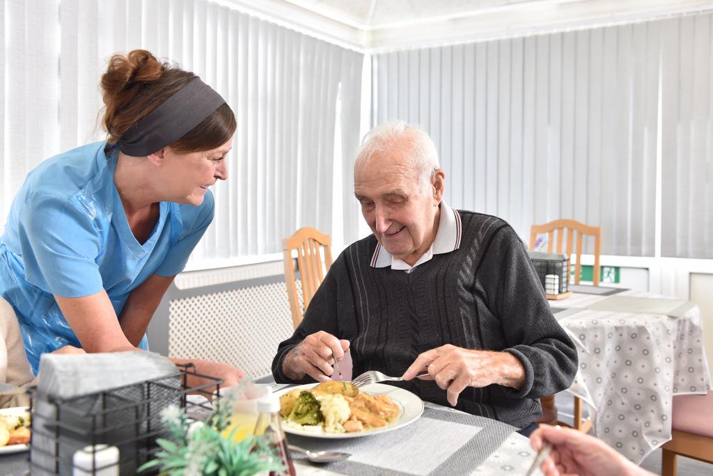 A caring staff member with a resident
